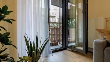 Apartment, Balcony, Courtyard View | Living room | Flat-screen TV