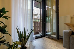 Apartment, Balcony, Courtyard View | Living room | Flat-screen TV