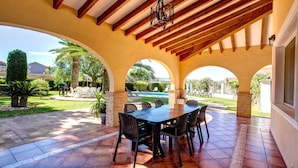 An outdoor patio with a pool, covered seating, and a view of the surrounding landscape. - Private Pool, Garden, Barbecue and Beach Nearby (Denia)