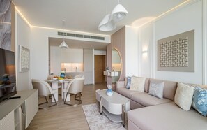A modern living room with a sofa, coffee table, and dining area.