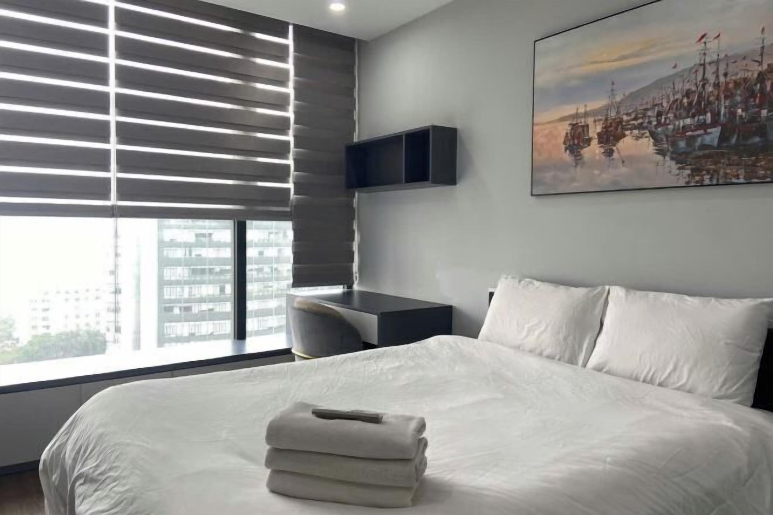 Premium bedding, desk, laptop workspace, blackout drapes