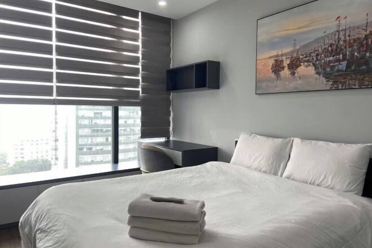 Premium bedding, desk, laptop workspace, blackout curtains