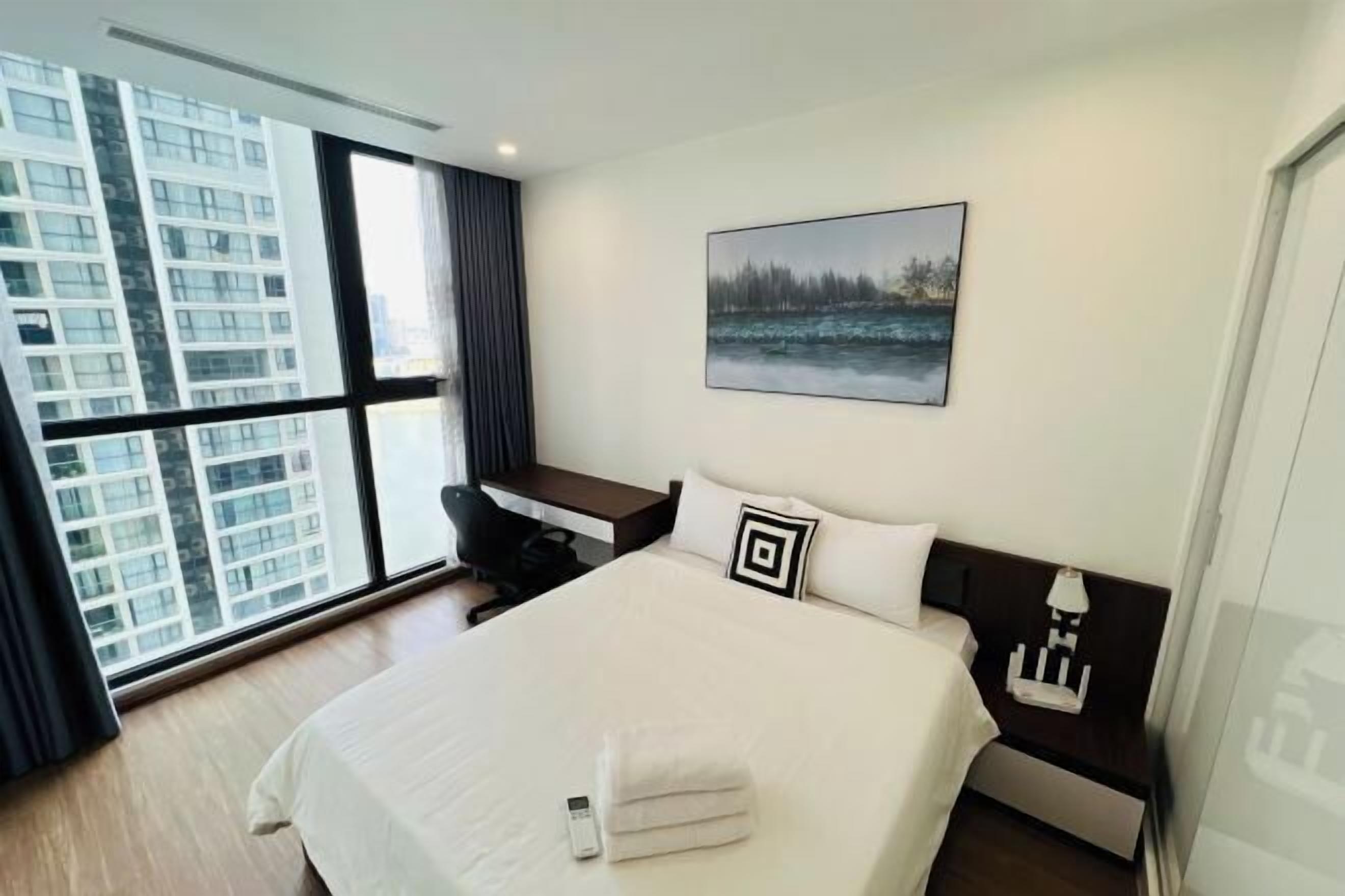 Premium bedding, desk, laptop workspace, blackout drapes