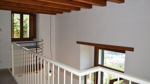 A staircase with white railings and wooden beams, leading to a balcony with a view of a cityscape. - Old Farmhouse "Green Apt",trekking lovers vacation homes with splendid views (Ravello)