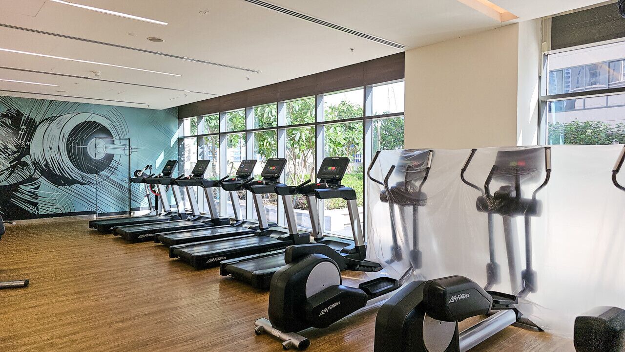 A gym with treadmills, ellipticals, and weight machines.