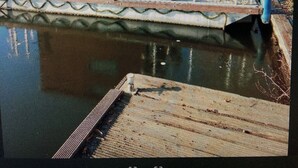 A wooden dock extending into a body of water, with a small building featuring two windows and a door. - Small houseboat ideal for fishing.   Contact us +49 177 5927586 (Lychen)
