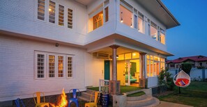 A two-story house with a porch, outdoor seating, and a fire pit. - goSTOPS Srinagar (Srinagar)