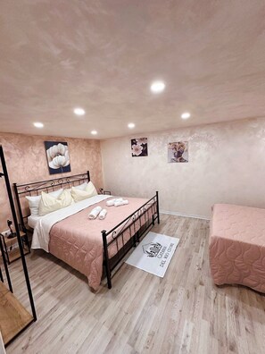 Restful retreat with a large bed, bedside table, and table with a lamp.