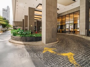 A modern building entrance with a paved pathway, large columns, and a glass facade. - 188 Suites KLCC by Soulasia (Kuala Lumpur)