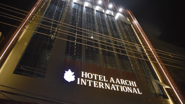 A building with the sign "HOTEL AARCHI INTERNATIONAL" and multiple illuminated windows. - Aarchi International (Raipur)