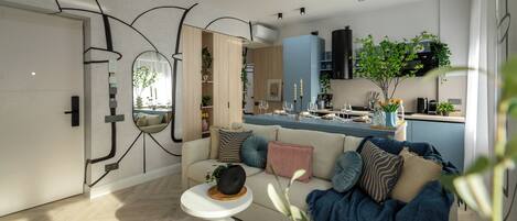 Een moderne woonkamer met een bank, salontafel en uitzicht op de keuken.
