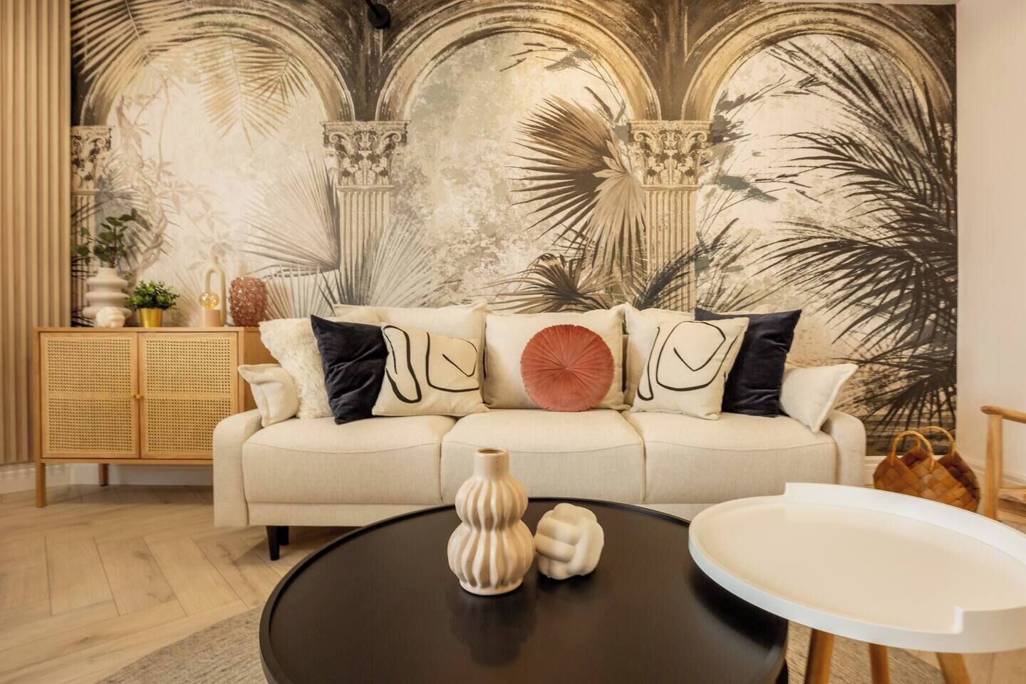A living room with a sofa, a round coffee table, and a cabinet.