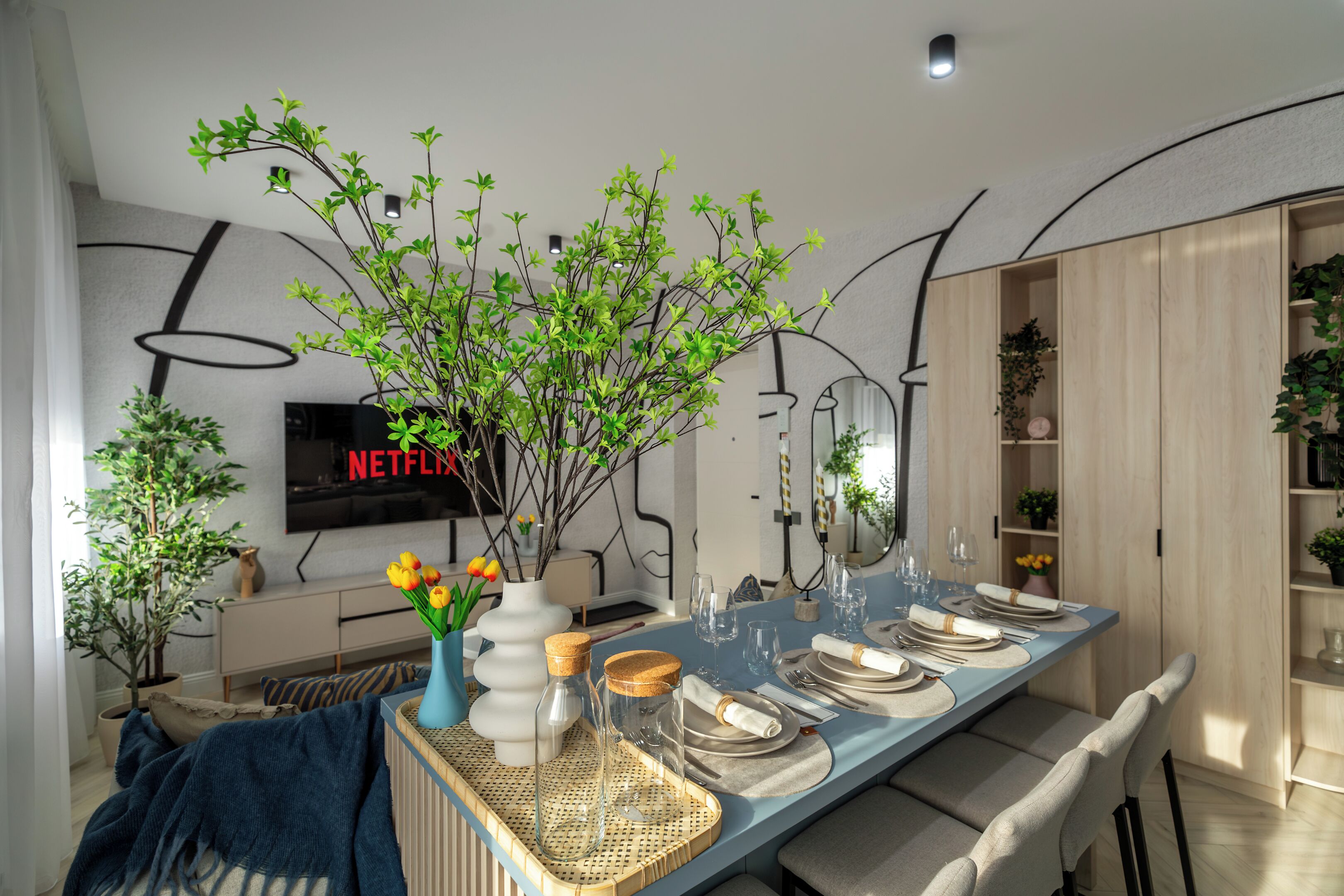 A modern dining area with a long table set for a meal, surrounded by potted plants and a television displaying 'NETFLIX'.