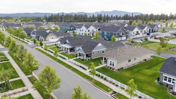 A residential area with modern houses, a well-maintained lawn, and a clear road. - Boutique CDA Retreat | Sleeps 6 • Near Downtown (Coeur d'Alene)