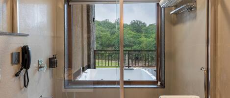 A modern bathroom with a glass-enclosed shower, a toilet, and a sink.