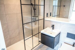 Shower, hair dryer, towels, shampoo