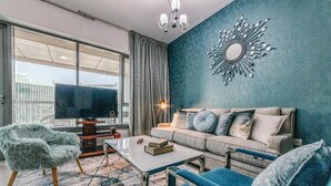 A modern living room with a sofa, armchairs, and a coffee table. - Bellavista - Spacious -1BR & Extra Room  (Dubai)