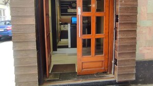 The exterior of The Premier Inn with a wooden facade and a large wooden door. - The Premier Inn (Kolkata)