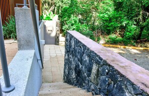Stunning outdoor staircase leads to the entrance of this contemporary building, surrounded by lush greenery and natural beauty.