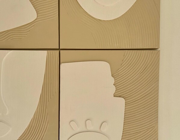 A wall with a textured pattern and a handprint design.