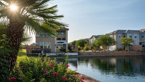 A residential area with modern houses, a swimming pool, and lush greenery. - Solmar at Terra Lago Private Lake House With Free Pool Heating for any 3nights stay (Indio)