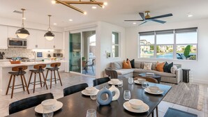 A modern kitchen with white cabinets, a built-in microwave, and pendant lighting. - Solmar at Terra Lago Private Lake House With Free Pool Heating for any 3nights stay (Indio)