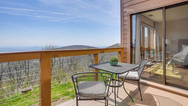 A balcony with a table and chairs, a potted plant, and a view of the landscape. - Pool Access: Scenic Condo in Wintergreen Resort! (Nellysford)