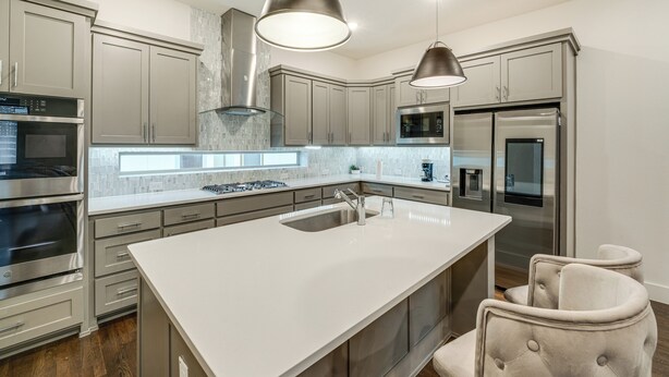 A modern kitchen with stainless steel appliances, a large island with a sink, and pendant lighting. - 10 Mi to Dtwn Dallas: Sleek Retreat w/ Balcony (Dallas)