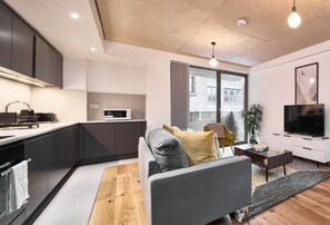 A modern kitchen with a built-in oven, microwave, and a large window.