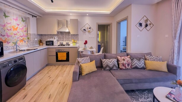 A modern apartment with a kitchen, dining area, and living room. - Elite Residence  (Nairobi)