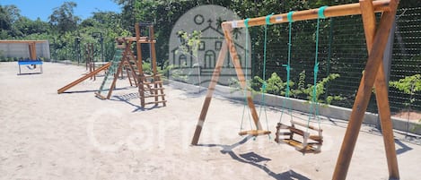 A playground with swings and climbing structures.