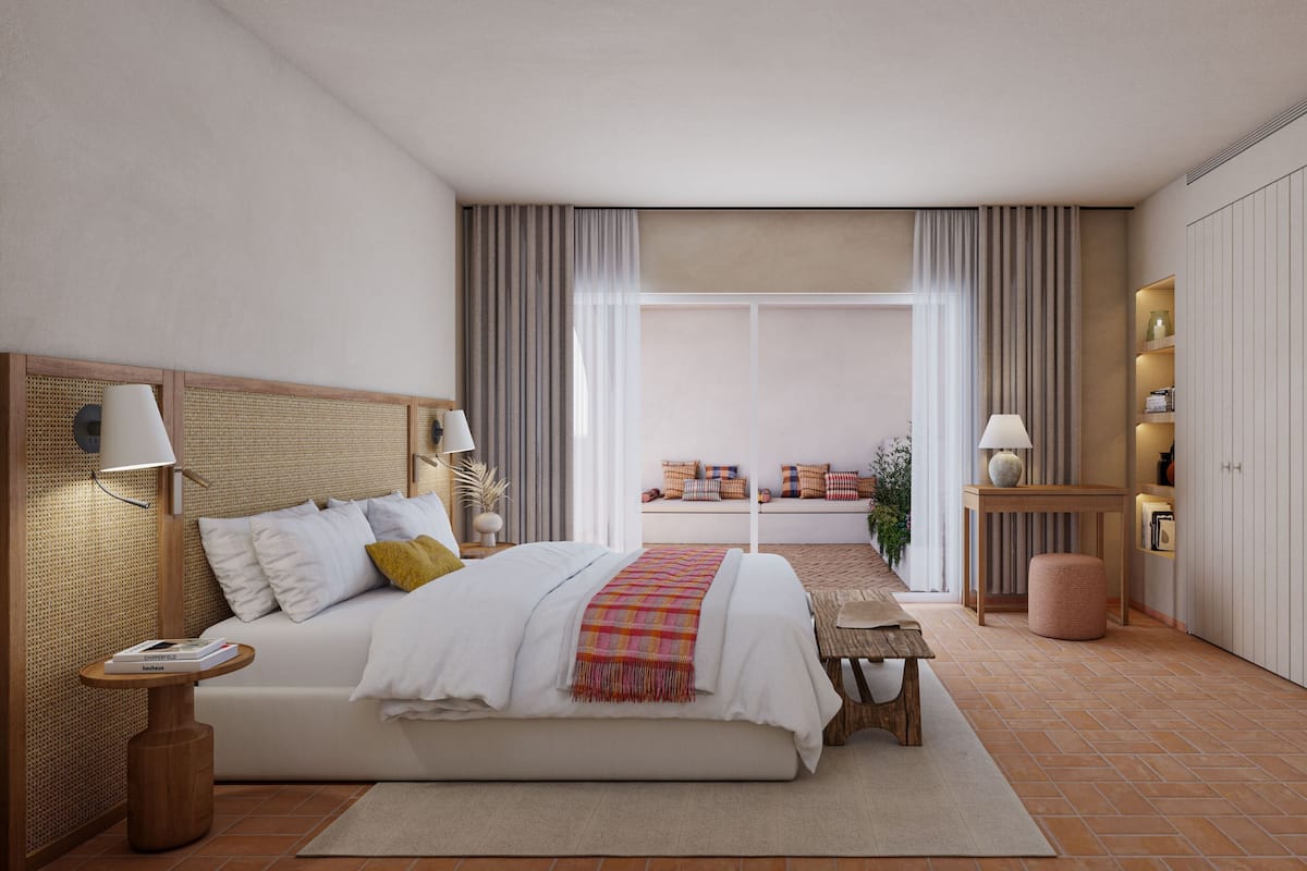 Un dormitorio moderno con una cama grande, mesitas de noche, un tocador, una pequeña mesa, un banco y un armario.