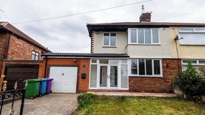 A two-story residential building with a garage, a conservatory, and a small garden area. - Hillfoot House (Liverpool)