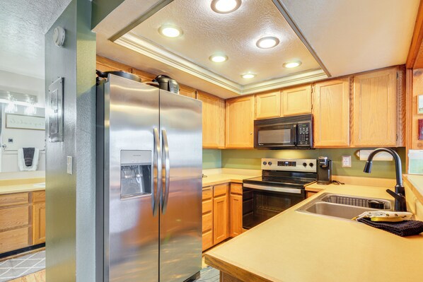 A modern kitchen with stainless steel appliances, wooden cabinets, and a built-in microwave. - 1/2 Mi to Brian Head Resort! Mtn-view Condo (Brian Head)