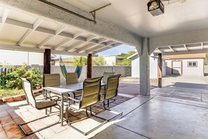 An outdoor patio with a table and chairs, a hammock, and a concrete floor. - 8 Mi to Linda Vista Trail: Tucson Home w/ Patio (Tucson)