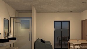 Un intérieur moderne comprenant une salle de bain, un coin salon et un espace repas.