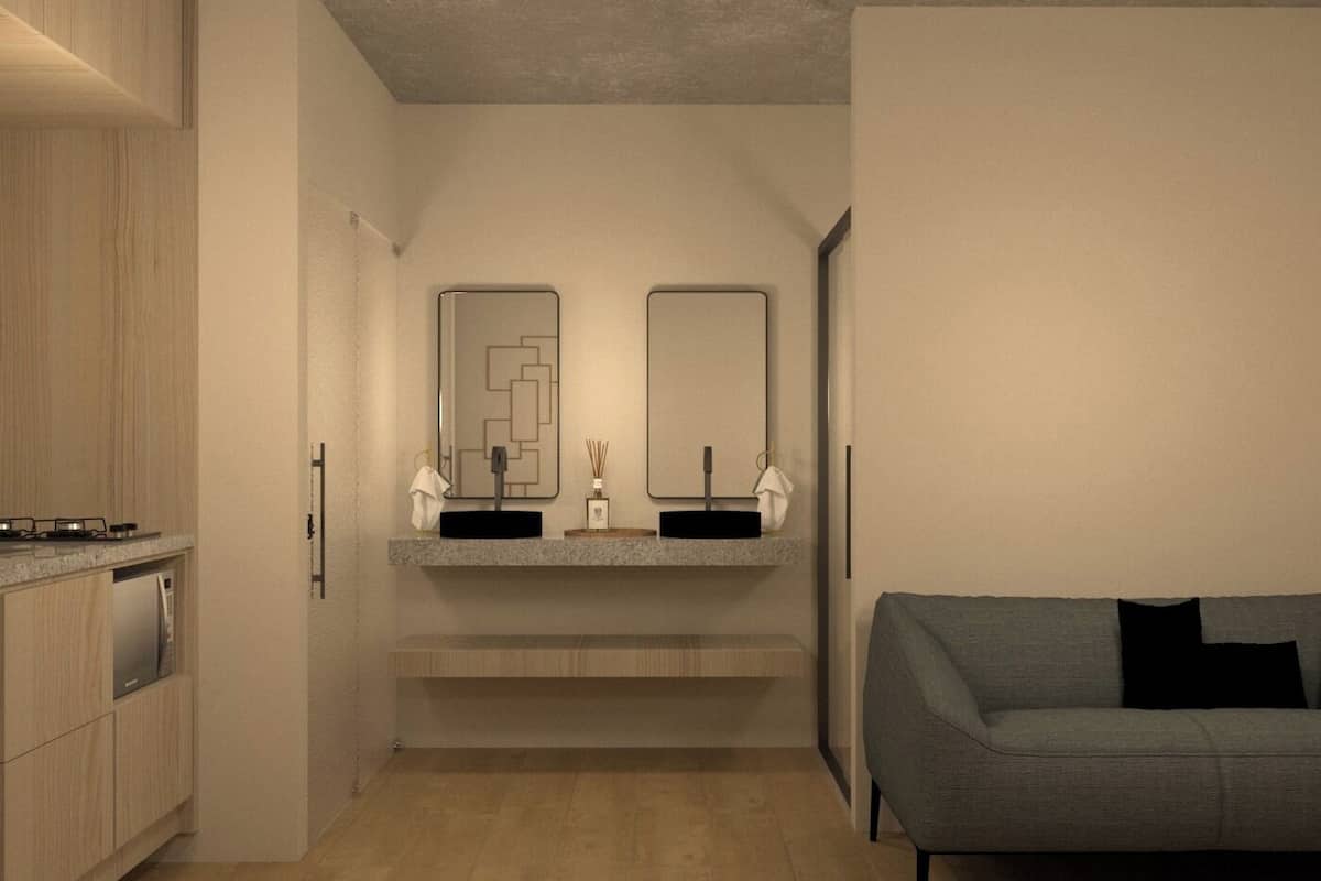 Un baño moderno con lavamanos doble, espejo y toallero.