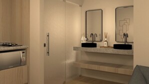 Une cuisine moderne équipée d’une cuisinière intégrée, d’un réfrigérateur et d’un évier à deux bacs, avec un miroir au-dessus.