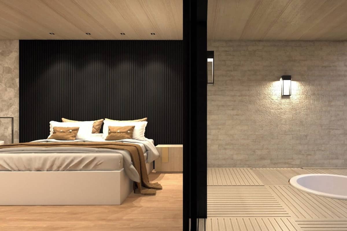 Un dormitorio moderno con una cama grande, mesitas de noche y vistas al exterior.