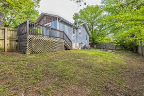 A two-story house with a wooden deck and a fenced yard. - Relax And Unwind In The Heart Of Fayetteville 2 Bedroom Home (Fayetteville)