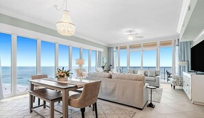 Relax in this ocean-view living area with a large window, flat-screen TV, and comfortable seating.