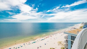 A beach view from a balcony with a clear sky and ocean. - Phoenix Gulf Shores Ii 2201 4 Bedroom Condo (Gulf Shores)