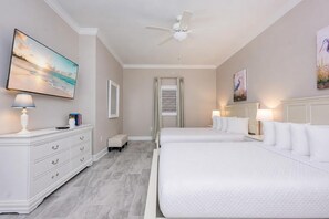 A hotel room with a bed, bedside tables, a ceiling fan, and artwork on the walls. - Phoenix Gulf Shores Ii 2404 3 Bedroom Condo (Gulf Shores)