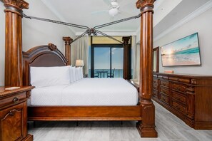 A four-poster bed with a balcony view, wooden furniture, and a painting on the wall. - Phoenix Gulf Shores Ii 2404 3 Bedroom Condo (Gulf Shores)