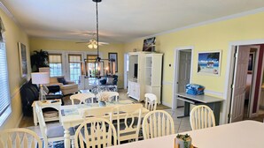 A dining area with a white table and chairs, a ceiling fan, and a chandelier. - Peaceful 3BR Ground Floor Condo w/ Intracoastal Waterway Views! (Myrtle Beach)