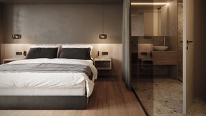 Ein modernes Schlafzimmer mit einem großen Bett, Nachttischen, einem kleinen Tisch und einem durch eine Glastür einsehbarer Badezimmer.