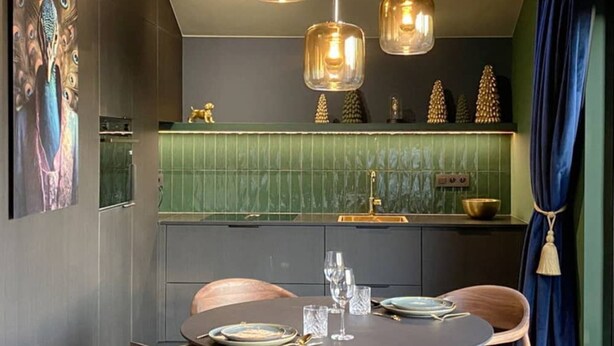 A modern dining area with a round table, wooden chairs, and pendant lighting. - House in Durbuy Near Town Center (Durbuy)