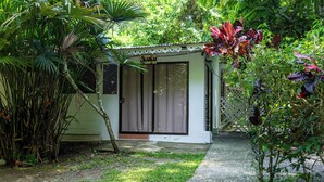 A small, single-story building with a door and a sign that reads "Lulu".