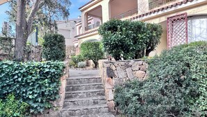 A stone staircase leading to a building with a balcony.