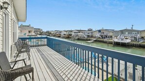 A balcony with a view of a marina and waterfront houses. - Second Star- 7BR Channel House-Pool, Putting Green (North Myrtle Beach)